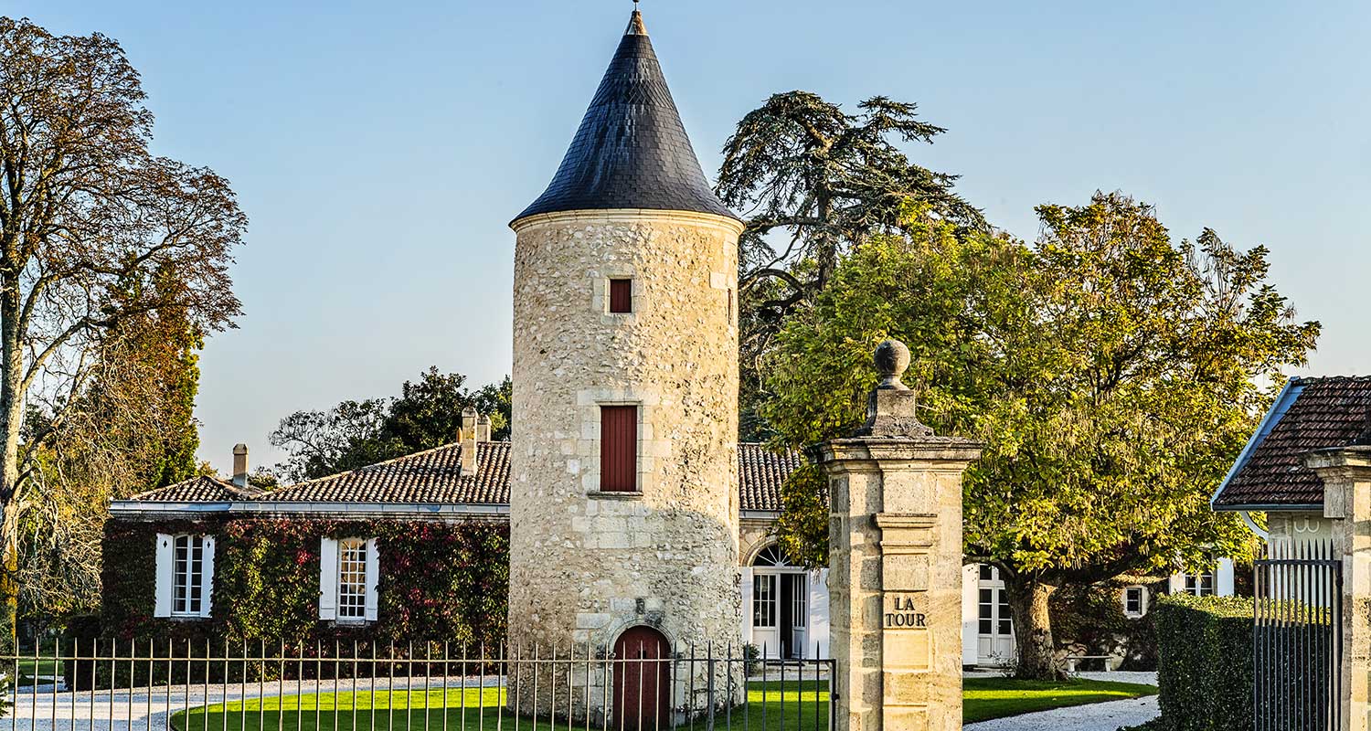 The round stone tower and courtyard entrance at Château Latour-Martillac