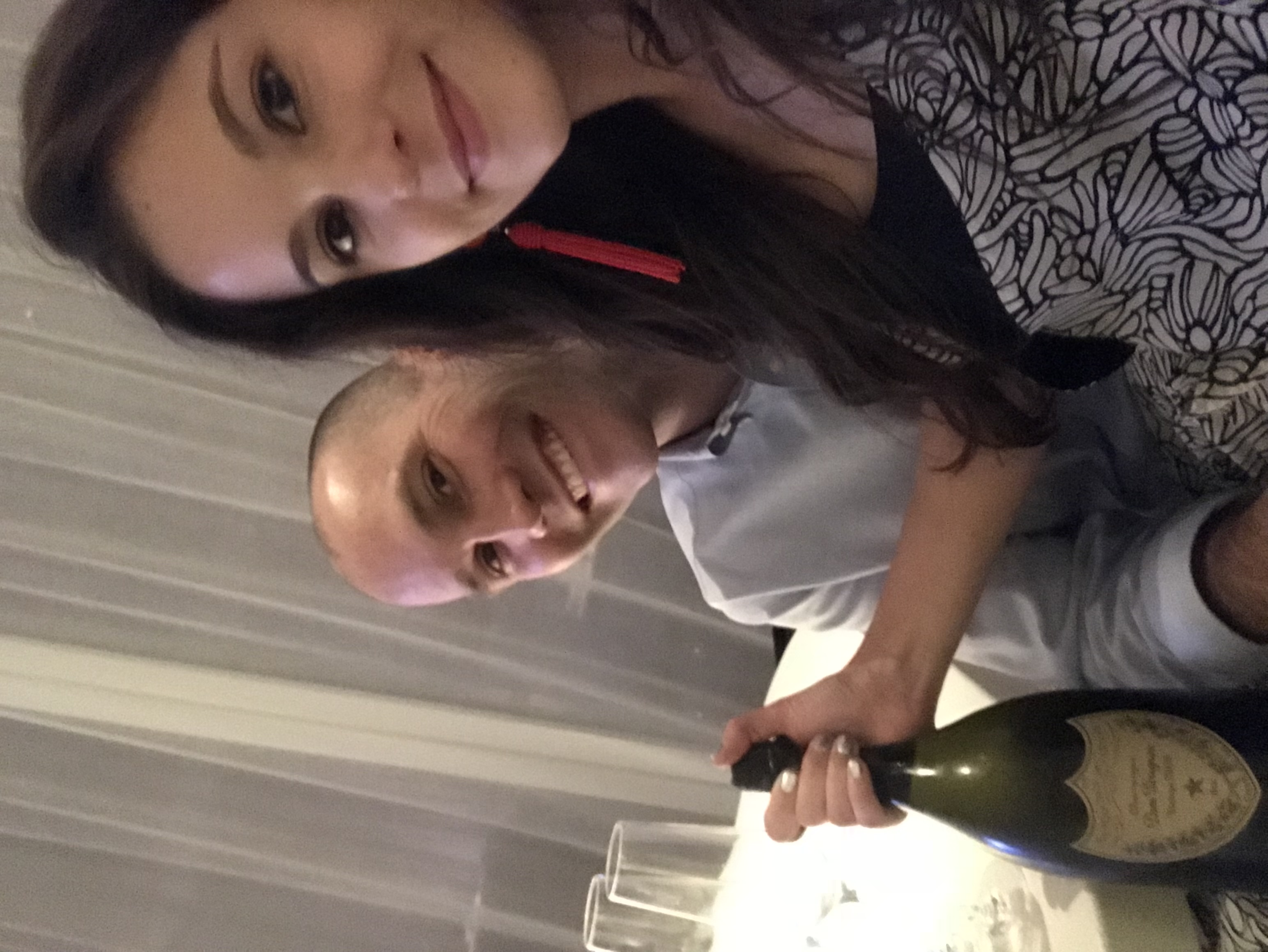 Chris and Amanda holding a bottle of Dom Pérignon